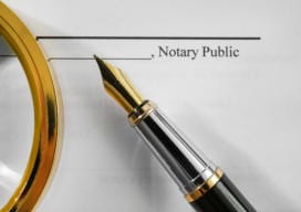 Notary public document, magnifier and fountain pen, close up view